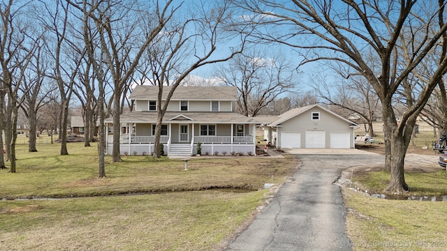 view of front facade with a garage, a porch, driveway, and a front lawn