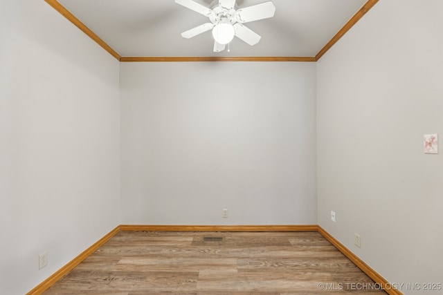 empty room featuring ceiling fan, baseboards, light wood-style floors, and ornamental molding