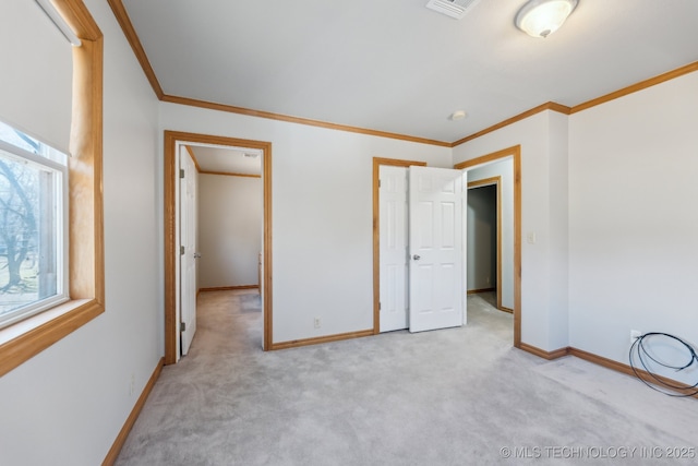 unfurnished bedroom featuring light colored carpet, baseboards, and ornamental molding