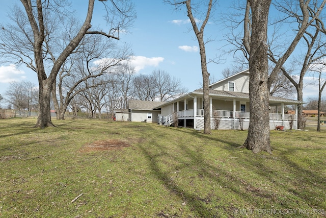 view of yard with covered porch and an attached garage