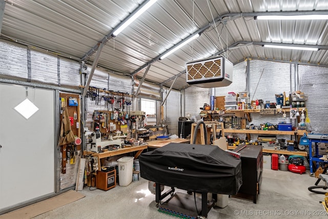 garage featuring a workshop area and metal wall