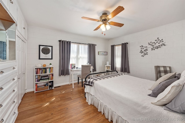 bedroom featuring light wood-style flooring and ceiling fan