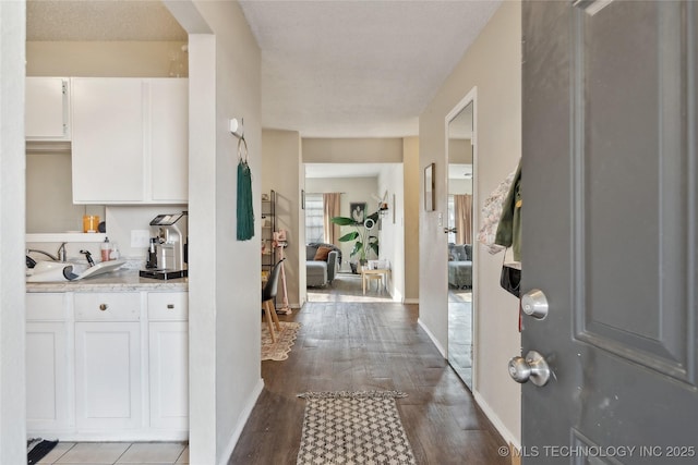 entrance foyer featuring baseboards and wood finished floors