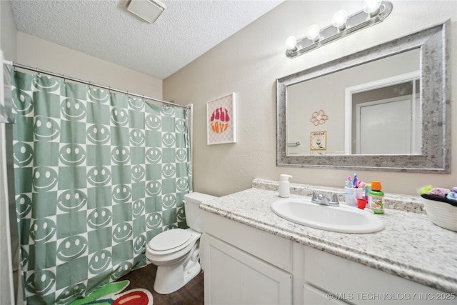 bathroom with vanity, a shower with shower curtain, wood finished floors, a textured ceiling, and toilet