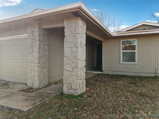 view of exterior entry featuring stone siding