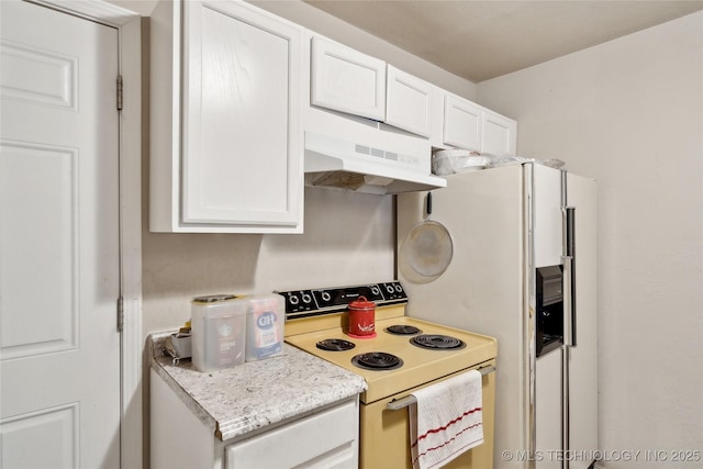 kitchen with under cabinet range hood, white appliances, and white cabinets