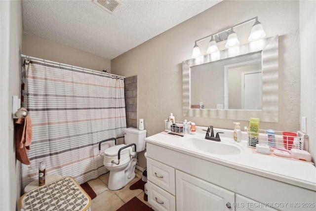 bathroom featuring vanity, visible vents, tile patterned flooring, a textured ceiling, and toilet