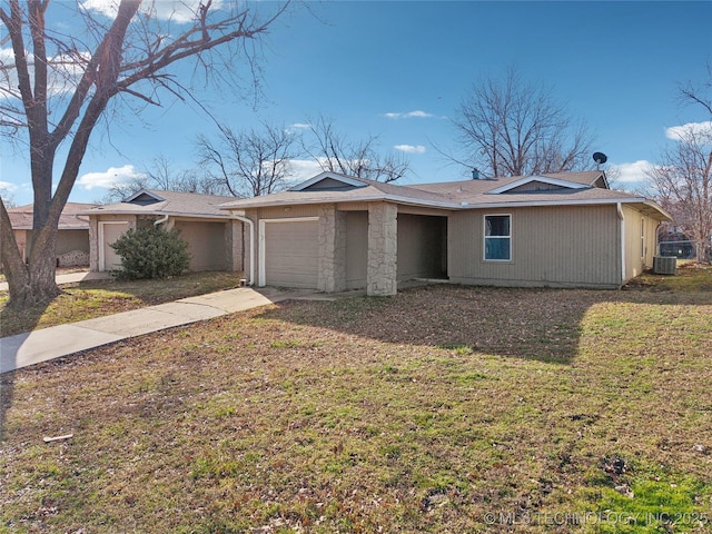 ranch-style house with a front yard, an attached garage, central AC unit, and driveway