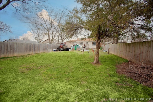 view of yard with a fenced backyard