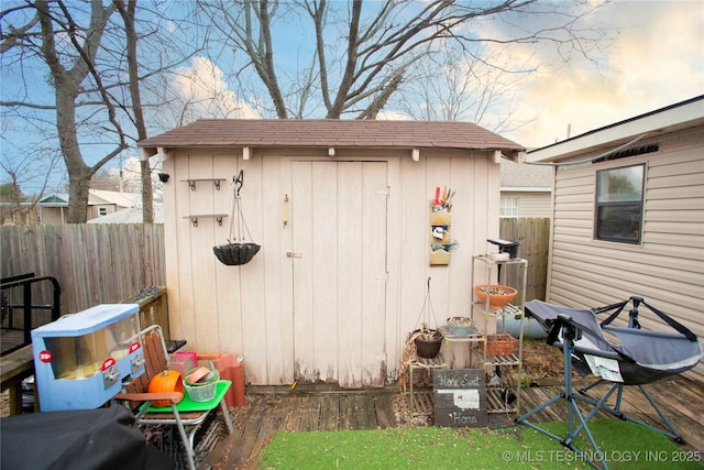 view of shed featuring fence