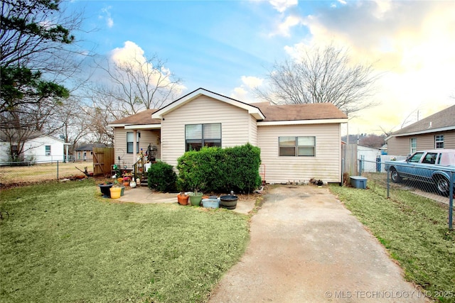 bungalow-style home with a front lawn and fence