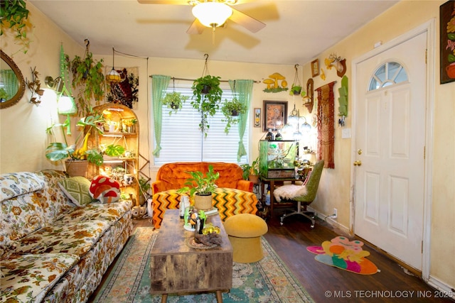 living room with baseboards, wood finished floors, and a ceiling fan