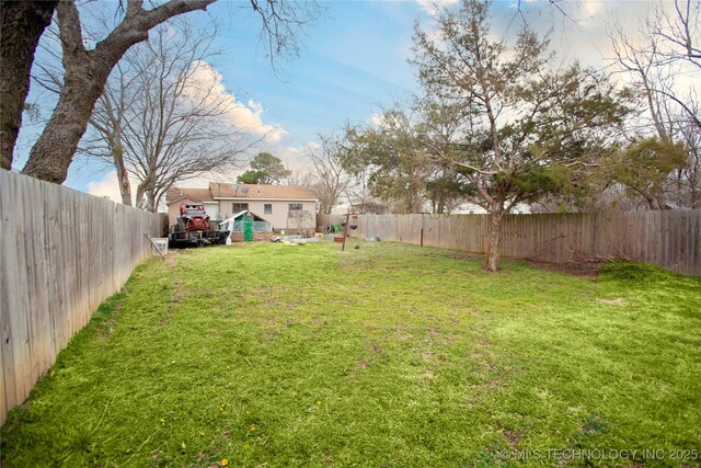 view of yard with a fenced backyard