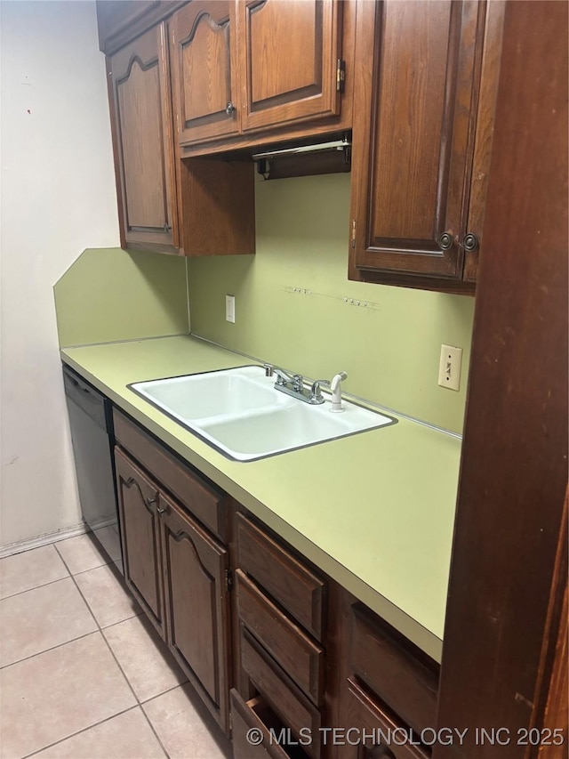 kitchen with dishwasher, light countertops, light tile patterned floors, and a sink