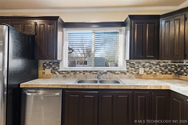 kitchen with a sink, stainless steel dishwasher, freestanding refrigerator, dark brown cabinetry, and light countertops