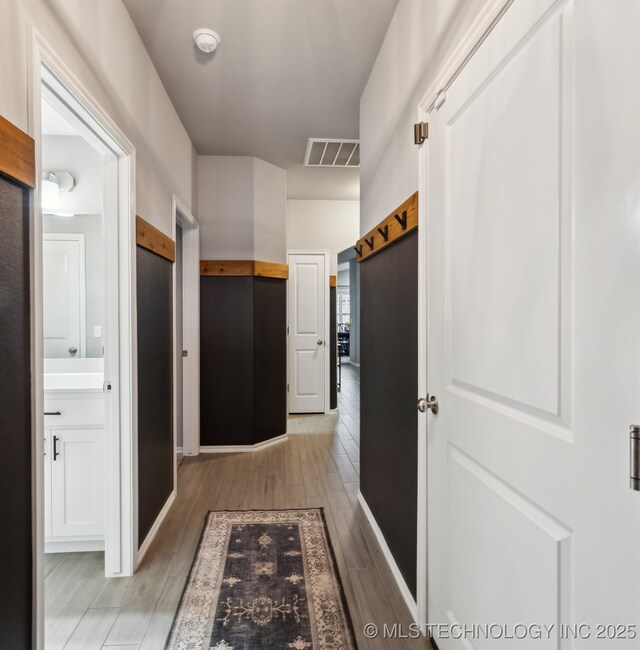 5117 S Nassau Ave, Sand Springs, OK 74063 - bathroom with wood finished floors and baseboards