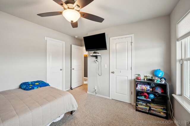5117 S Nassau Ave, Sand Springs, OK 74063 - carpeted bedroom with multiple windows and a ceiling fan