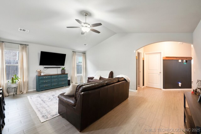 5117 S Nassau Ave, Sand Springs, OK 74063 - living area featuring arched walkways, ceiling fan, vaulted ceiling, and wood finished floors