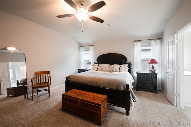 bedroom featuring visible vents, carpet flooring, baseboards, and vaulted ceiling