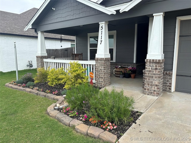 5117 S Nassau Ave, Sand Springs, OK 74063 - doorway to property with a porch, brick siding, and a lawn