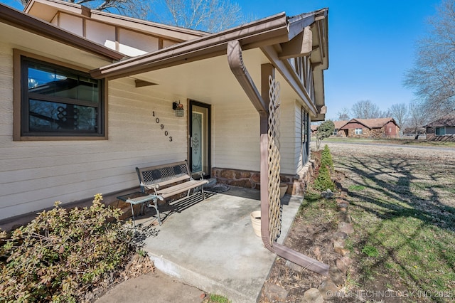 view of exterior entry with a patio area