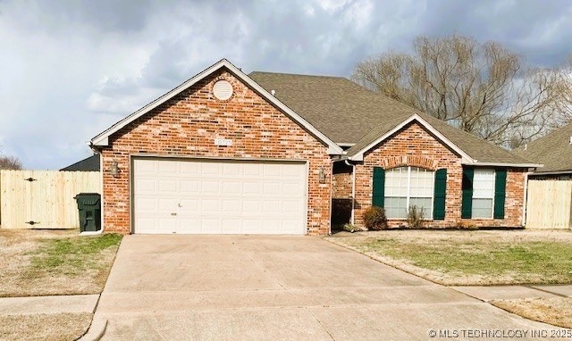 single story home featuring brick siding, concrete driveway, an attached garage, and fence