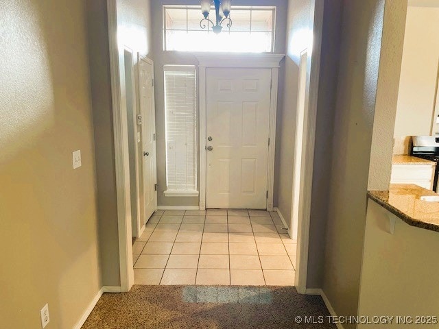 interior space with light tile patterned floors and a notable chandelier