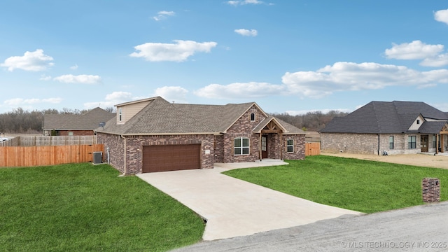 view of front of property with fence, driveway, an attached garage, a front lawn, and central air condition unit