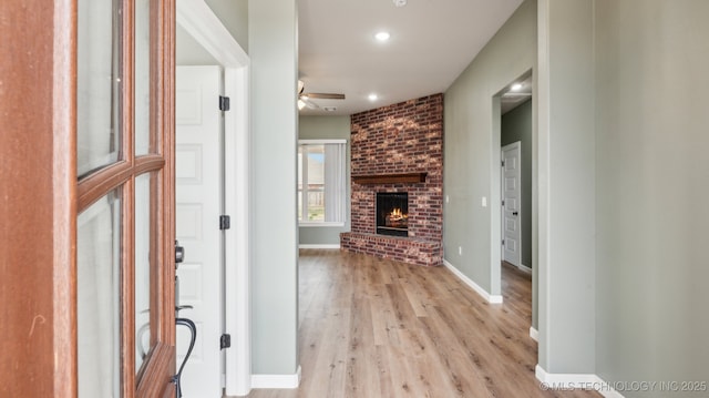 entrance foyer featuring light wood-type flooring, a ceiling fan, recessed lighting, a fireplace, and baseboards