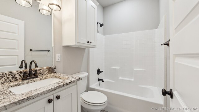 bathroom featuring vanity, toilet, and tub / shower combination