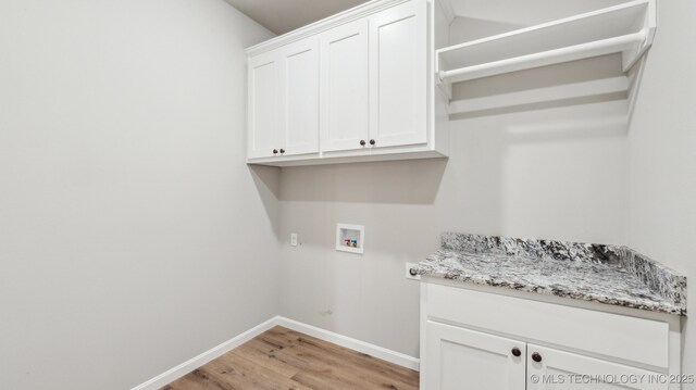 clothes washing area featuring hookup for a washing machine, light wood-style flooring, cabinet space, and baseboards