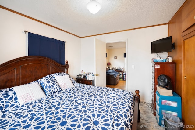 bedroom with a textured ceiling, carpet floors, and ornamental molding