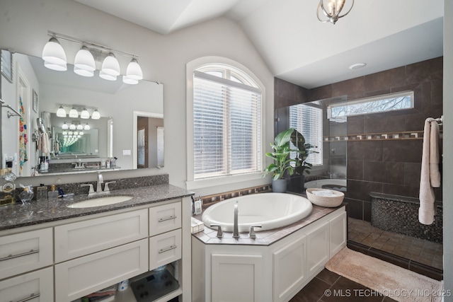 full bathroom with walk in shower, a bath, vanity, tile patterned flooring, and vaulted ceiling