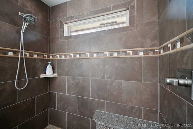 bathroom with tiled shower