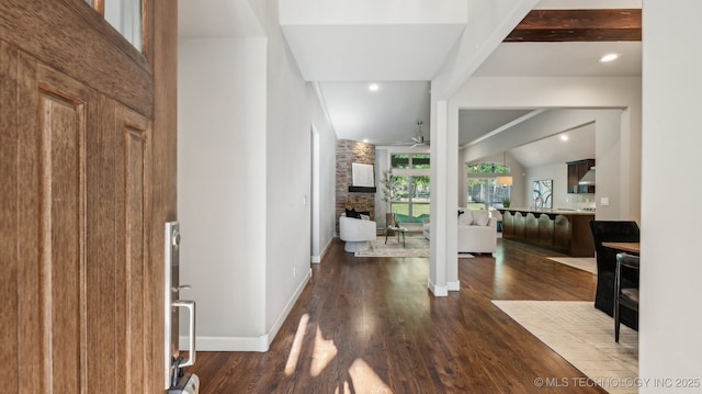 foyer featuring a large fireplace, a ceiling fan, wood finished floors, baseboards, and recessed lighting