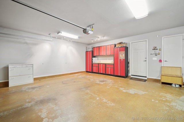 garage featuring a garage door opener and baseboards