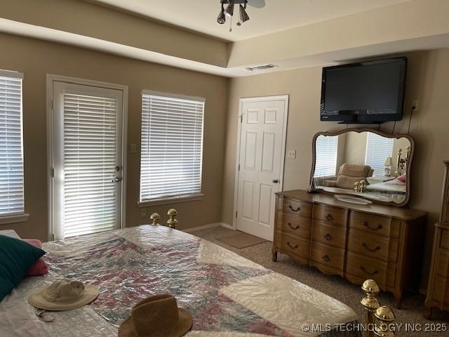 bedroom featuring visible vents and light colored carpet