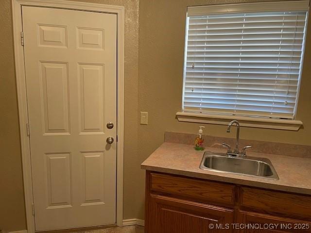 kitchen featuring light countertops and a sink