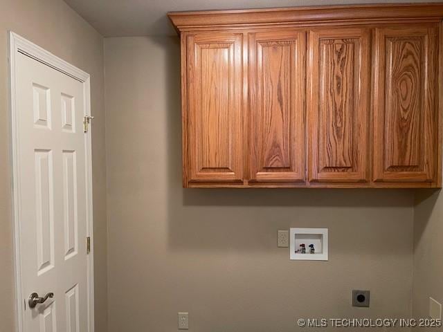 washroom featuring cabinet space, electric dryer hookup, and hookup for a washing machine