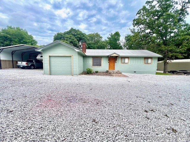 ranch-style home with gravel driveway, a chimney, metal roof, a carport, and an attached garage