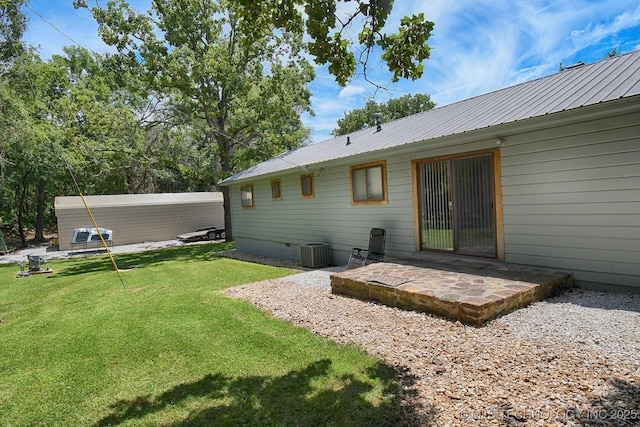 back of house featuring a lawn, a patio, metal roof, crawl space, and central AC unit