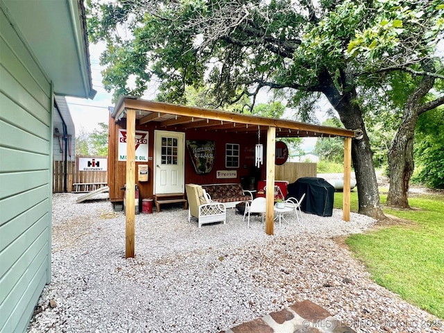 exterior space featuring an outdoor structure and fence