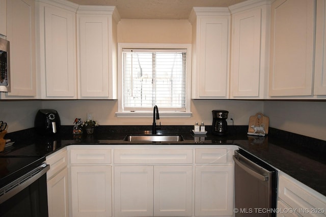 kitchen with white cabinets, appliances with stainless steel finishes, and a sink