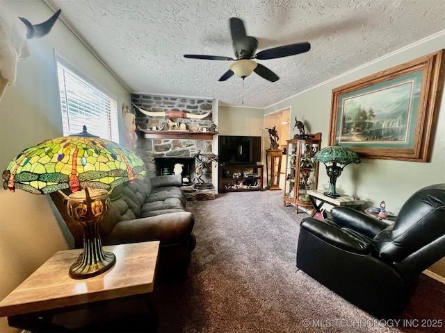 carpeted living area featuring a textured ceiling, a stone fireplace, ceiling fan, and ornamental molding