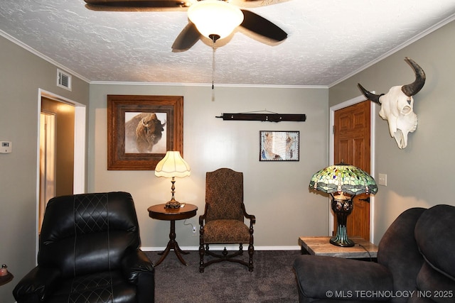 sitting room with visible vents, carpet, crown molding, and a textured ceiling