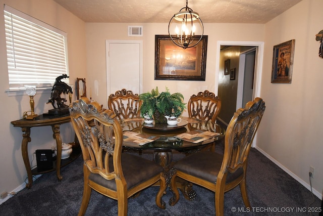 carpeted dining area with a notable chandelier, baseboards, visible vents, and a textured ceiling