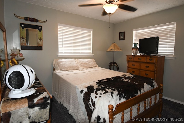 bedroom featuring a ceiling fan and baseboards