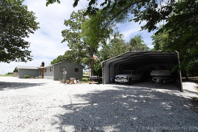 exterior space featuring a carport and gravel driveway