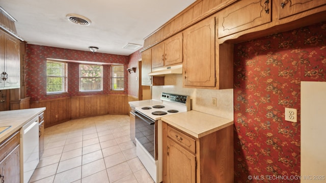 kitchen with under cabinet range hood, visible vents, white appliances, and light countertops