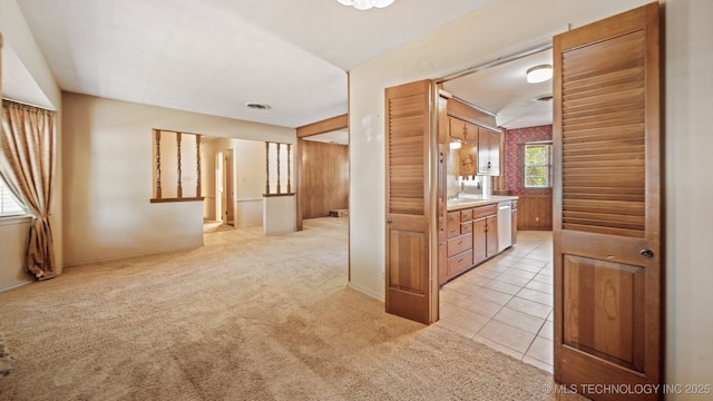 interior space featuring visible vents, light colored carpet, and light tile patterned flooring